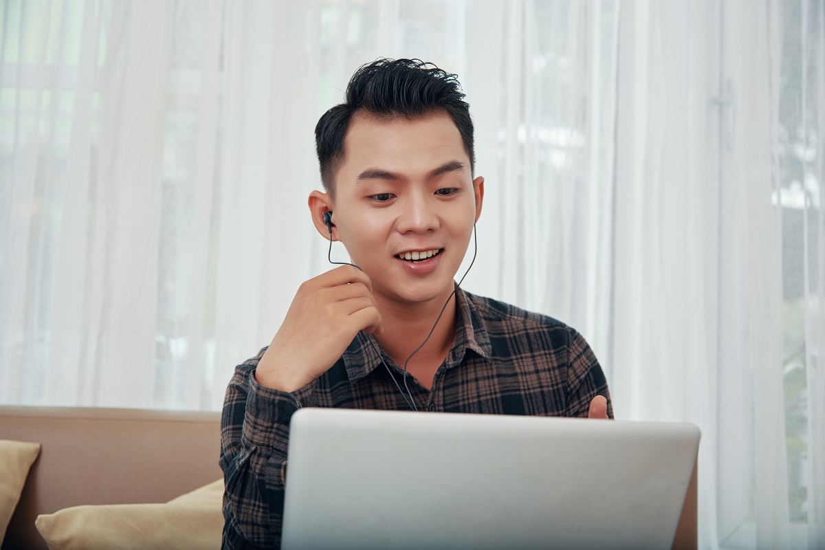 Asian man having video call at home